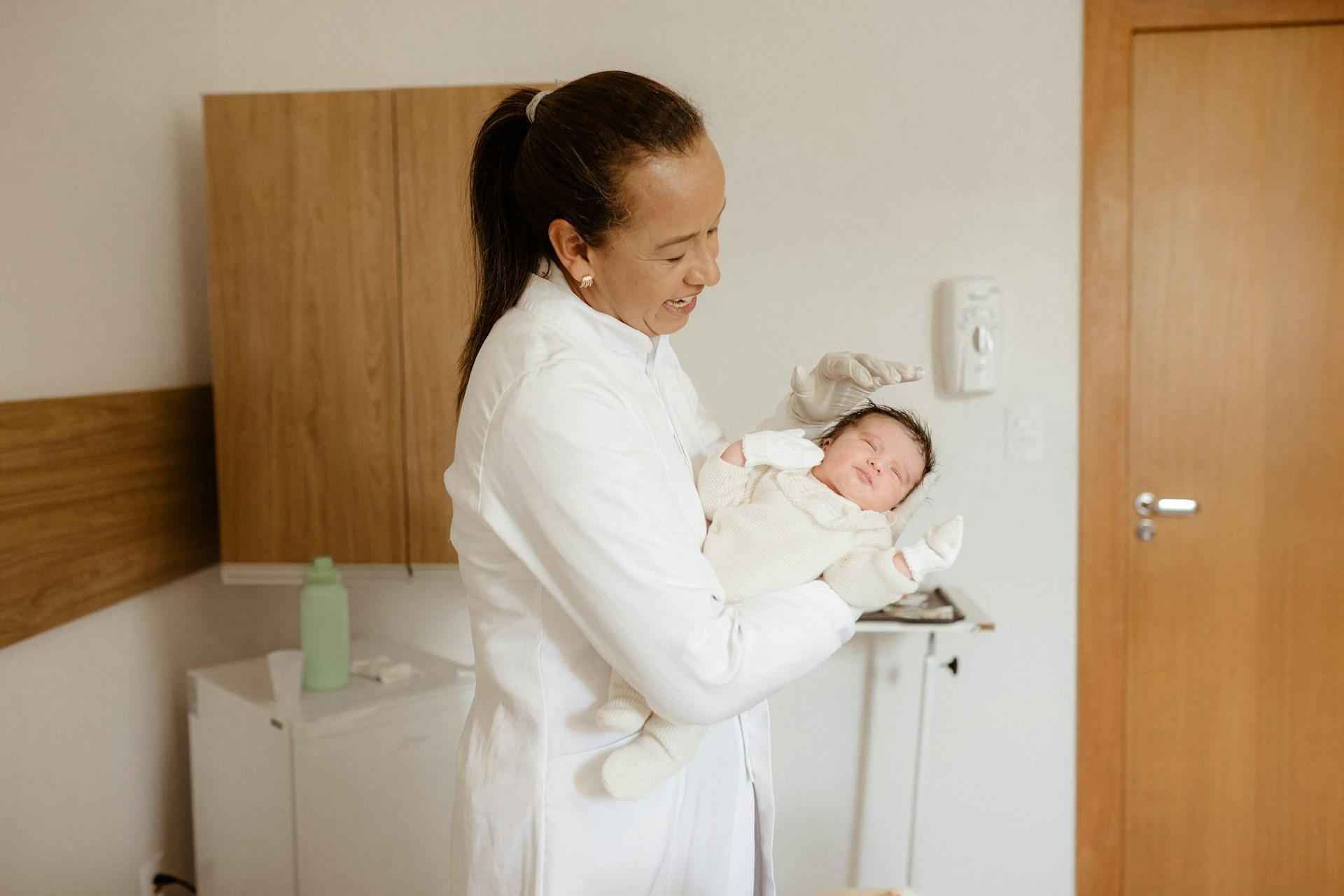 Parent checking newborn's temperature at home