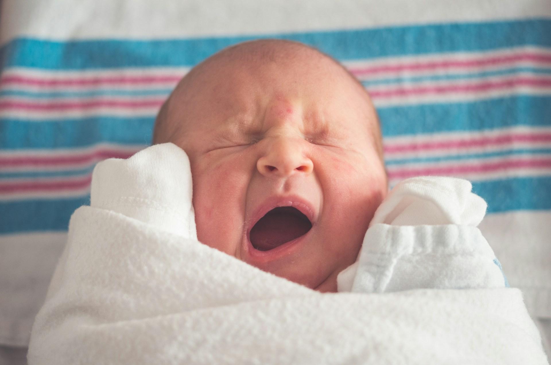 Parent holding newborn skin to skin on chest